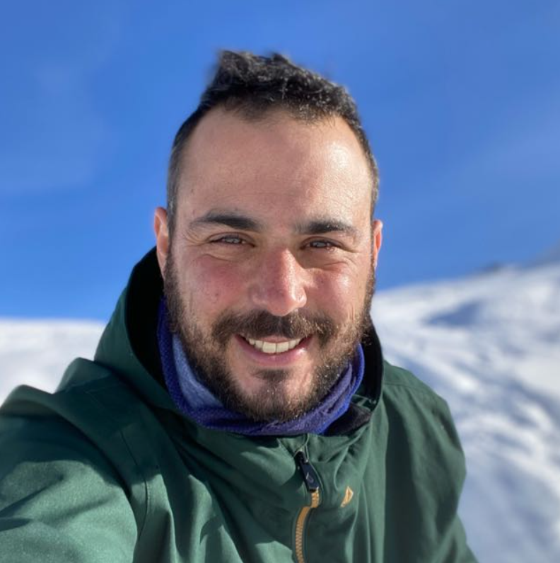 Gal Gershon smiling in the snow with mountains behind him